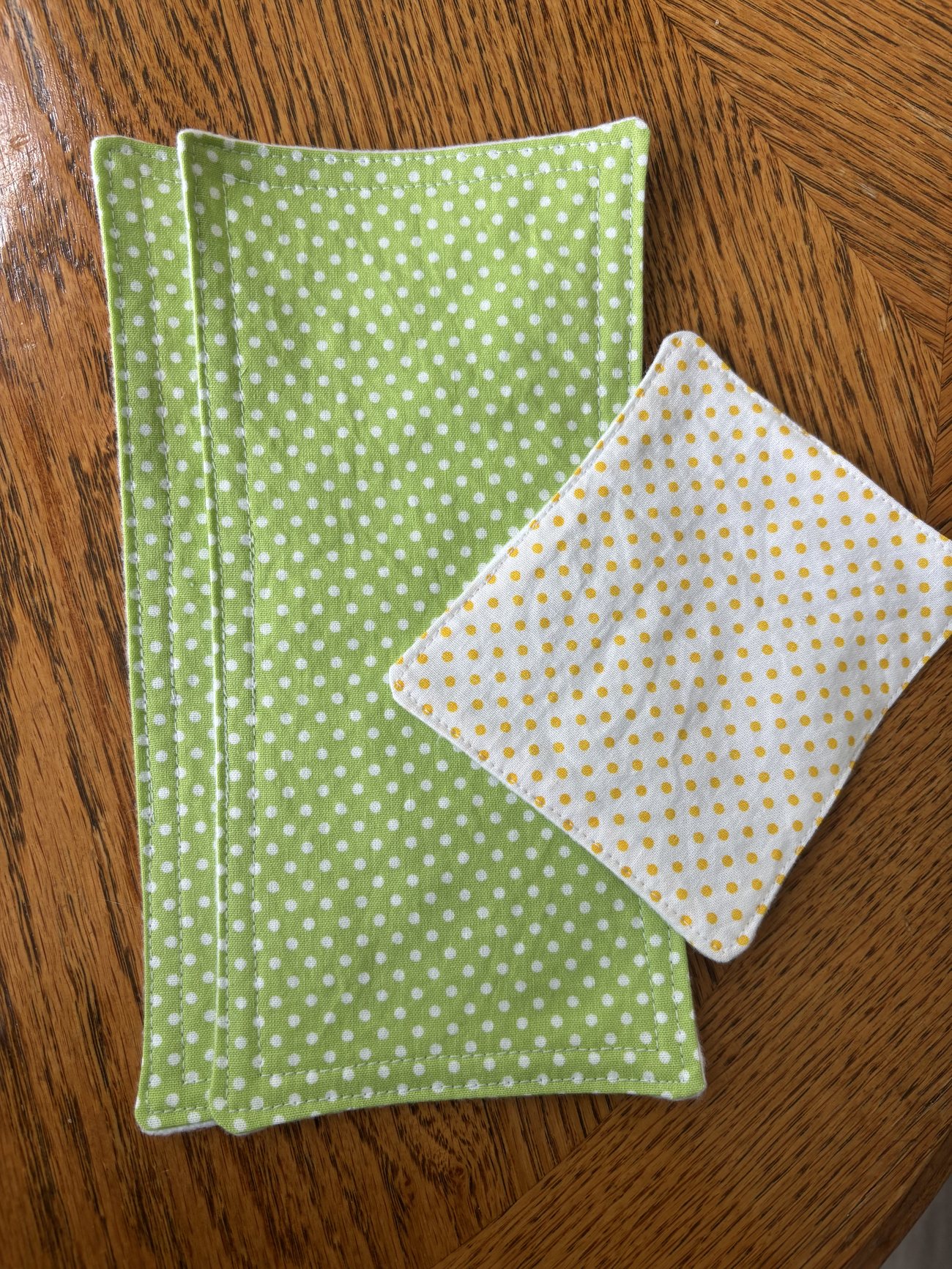 Two handmade Bust-ease cotton comfort cloths showing the soft cotton prints and stitched edges